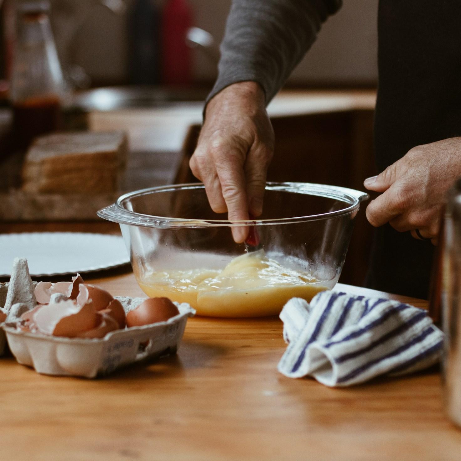 Community members working together in a contemporary kitchen, exchanging recipes and cooking skills